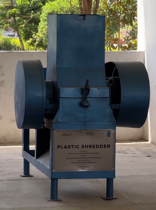 A blue industrial plastic shredder labelled "Plastic Shredder".