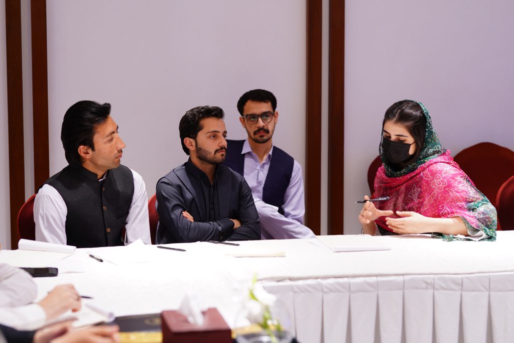 Workshop participants seated at a conference table.